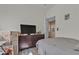 Neutral bedroom features large dresser, tv, and boxes at 223 Positive Point St, Henderson, NV 89012