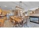 Bright dining area open to the kitchen with stainless appliances and wood-look tile at 223 Positive Point St, Henderson, NV 89012