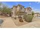 Townhouse exterior featuring desert landscaping with rocks and small bushes and trees at 223 Positive Point St, Henderson, NV 89012