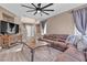 Bright open floor plan featuring a sectional couch and a fireplace with wood tile at 223 Positive Point St, Henderson, NV 89012