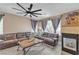 Living room featuring fireplace, dark brown leather sectional, and wood-look tile at 223 Positive Point St, Henderson, NV 89012