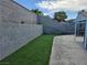 Large backyard featuring a combination of well-maintained artificial turf and a spacious concrete patio at 2370 Ray Kanel Dr, Las Vegas, NV 89156