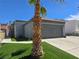 This attractive home boasts an artificial lawn and convenient driveway at 2370 Ray Kanel Dr, Las Vegas, NV 89156