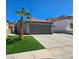 This beautiful home features a well-manicured lawn and a spacious driveway at 2370 Ray Kanel Dr, Las Vegas, NV 89156
