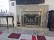 Elegant living room fireplace with a decorative screen, marble surround and hearth, and displayed decor at 2370 Ray Kanel Dr, Las Vegas, NV 89156