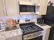 Updated kitchen features stainless steel appliances and light countertops at 2370 Ray Kanel Dr, Las Vegas, NV 89156