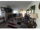 Living room features a stone fireplace, a modern rug, and comfortable seating, perfect for gatherings at 2370 Ray Kanel Dr, Las Vegas, NV 89156