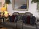 Living room features a plush sofa, decorative pillows and a large mirror at 2370 Ray Kanel Dr, Las Vegas, NV 89156
