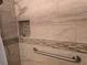 Tiled shower with built-in shelving and grab bar at 2370 Ray Kanel Dr, Las Vegas, NV 89156