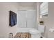 Cozy bathroom featuring a shower-tub combo with sliding glass doors and a classic white toilet at 2504 Courlan Dr, North Las Vegas, NV 89084