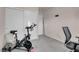 Carpeted bedroom with exercise bike and chair at 2504 Courlan Dr, North Las Vegas, NV 89084