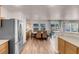 Open layout showcases the dining area with backyard access and stylish seating, connecting seamlessly to the kitchen at 2504 Courlan Dr, North Las Vegas, NV 89084