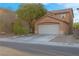 Charming two-story home with a well-maintained lawn and a two-car garage, showcasing curb appeal at 2504 Courlan Dr, North Las Vegas, NV 89084