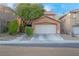 Charming two-story home with a well-maintained lawn and a two-car garage, showcasing curb appeal at 2504 Courlan Dr, North Las Vegas, NV 89084