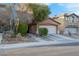 Charming two-story home with a well-maintained lawn and a two-car garage, showcasing curb appeal at 2504 Courlan Dr, North Las Vegas, NV 89084