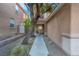 Inviting front entrance with a walkway leading to a charming porch, framed by lush greenery at 2504 Courlan Dr, North Las Vegas, NV 89084