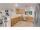 Spacious kitchen featuring ample counter space, stainless steel appliances, and an open view of the living area at 2504 Courlan Dr, North Las Vegas, NV 89084