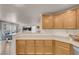 Bright kitchen featuring updated cabinetry and countertops, with an open view to the living room at 2504 Courlan Dr, North Las Vegas, NV 89084