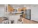 Well-lit kitchen boasts stainless steel appliances, ample countertop space, and a breakfast bar with seating at 2504 Courlan Dr, North Las Vegas, NV 89084