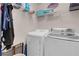 Functional laundry room with washer, dryer, wire shelving, and extra storage space at 2504 Courlan Dr, North Las Vegas, NV 89084