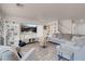 Comfortable living room features hardwood floors, a large TV, and neutral colors, creating a relaxing atmosphere at 2504 Courlan Dr, North Las Vegas, NV 89084