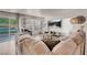 Cozy living room features a comfortable sofa, modern decor, and a view of the backyard pool through the sliding glass door at 2504 Courlan Dr, North Las Vegas, NV 89084