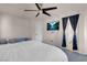 Spacious main bedroom featuring a ceiling fan, television, and cozy seating area at 2504 Courlan Dr, North Las Vegas, NV 89084