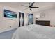 Bright main bedroom featuring a ceiling fan, television, and large windows at 2504 Courlan Dr, North Las Vegas, NV 89084