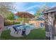 Relaxing backyard pool with spa, lounge chairs, umbrella, gazebo, and well-manicured landscaping provides a private oasis at 2504 Courlan Dr, North Las Vegas, NV 89084