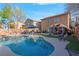 Stunning backyard oasis featuring a large pool, comfortable seating areas, and well-manicured landscaping at 2504 Courlan Dr, North Las Vegas, NV 89084