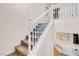 Carpeted staircase with white banister, leading to the upper level of the home at 2504 Courlan Dr, North Las Vegas, NV 89084