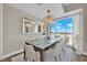 Contemporary dining room features a modern chandelier, a large mirror, a dining table, and city views from the large window at 2700 Las Vegas Blvd # 1803, Las Vegas, NV 89109