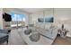 The spacious living room offers modern decor, hardwood floors, a comfortable gray sofa, and a beautiful outdoor view at 2700 Las Vegas Blvd # 1803, Las Vegas, NV 89109