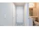 Hallway bathroom with a single sink and white door entrance to shower at 3043 Jacaranda Dr, Las Vegas, NV 89117