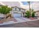 Inviting two-story home with a two-car garage, manicured landscaping, and a well-maintained front yard at 3043 Jacaranda Dr, Las Vegas, NV 89117