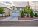 Traditional two-story home with a two-car garage, front yard landscaping, and inviting curb appeal at 3043 Jacaranda Dr, Las Vegas, NV 89117