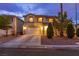 Inviting two-story house with lush landscaping, a wide driveway, and a welcoming entrance at 3043 Jacaranda Dr, Las Vegas, NV 89117