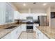 Modern kitchen with granite countertops, stainless steel appliances, white cabinets, and ample counter space at 3043 Jacaranda Dr, Las Vegas, NV 89117