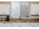 Kitchen features granite counters, stainless steel appliances, and white cabinetry for a modern and functional space at 3043 Jacaranda Dr, Las Vegas, NV 89117