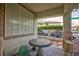 Cozy covered patio area with a small table and chairs, offering a peaceful outdoor space at 3043 Jacaranda Dr, Las Vegas, NV 89117