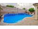 Sparkling pool with attached spa featuring blue tile accents and a tranquil waterfall effect in a private backyard setting at 3043 Jacaranda Dr, Las Vegas, NV 89117