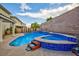 Inviting backyard pool and spa featuring a brick wall and lush greenery, perfect for relaxation and entertaining at 3043 Jacaranda Dr, Las Vegas, NV 89117