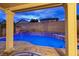 A backyard pool viewed from a covered patio with elegant white columns at 3043 Jacaranda Dr, Las Vegas, NV 89117