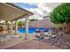 Backyard oasis with a beautiful pool, covered patio, and ample seating for outdoor enjoyment and relaxation at 3043 Jacaranda Dr, Las Vegas, NV 89117