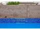 Inviting pool with blue tile detail and brick privacy wall, perfect for outdoor relaxation at 3043 Jacaranda Dr, Las Vegas, NV 89117