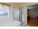 Bright bathroom featuring a glass-enclosed shower with a window for natural light at 3043 Jacaranda Dr, Las Vegas, NV 89117