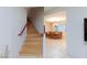Hardwood staircase leading to a dining room with a chandelier, and natural light at 3043 Jacaranda Dr, Las Vegas, NV 89117