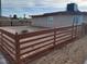 View of the backyard, featuring a wooden fence surrounding desert landscaping at 310 E Lake Mead Blvd, North Las Vegas, NV 89030