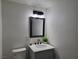 Bathroom featuring a vanity with a stone countertop, modern fixtures, and stylish mirror at 310 E Lake Mead Blvd, North Las Vegas, NV 89030