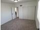 Bedroom with carpeted floor, large sliding door closet, and white walls at 310 E Lake Mead Blvd, North Las Vegas, NV 89030